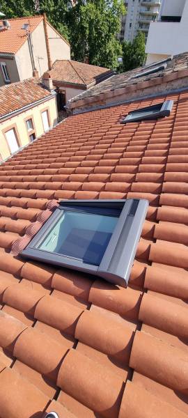 ouvrage d'une fenêtre de toit électrique de chez velux avec un volet roulant électrique a Toulouse par les 2 charpentiers.